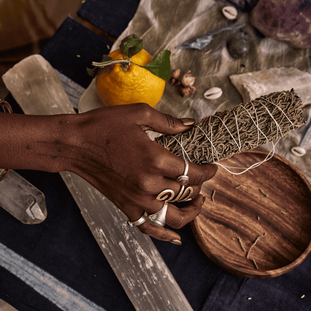 woman holding sage in an end of year reflections